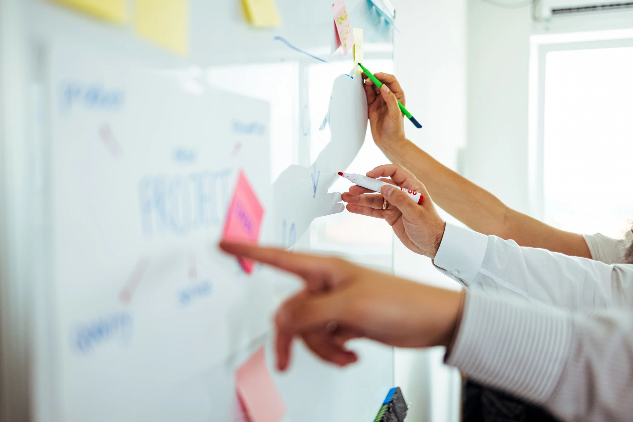 Facilitator sketching ideas on a whiteboard during a workshop