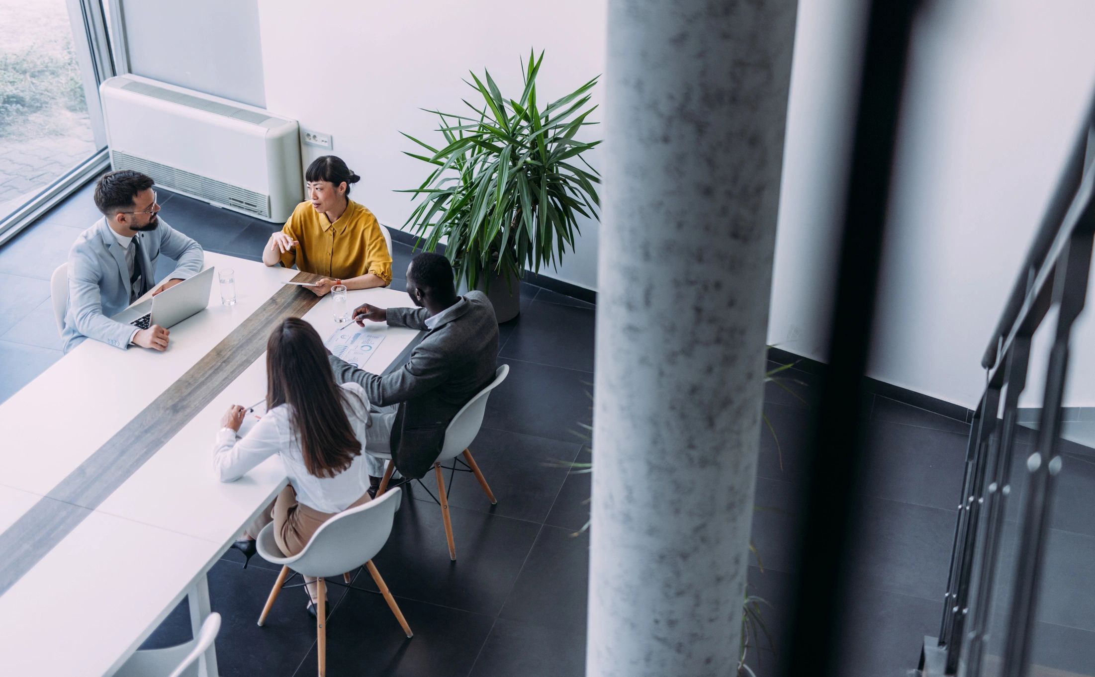 Overhead view of a business meeting around a conference table