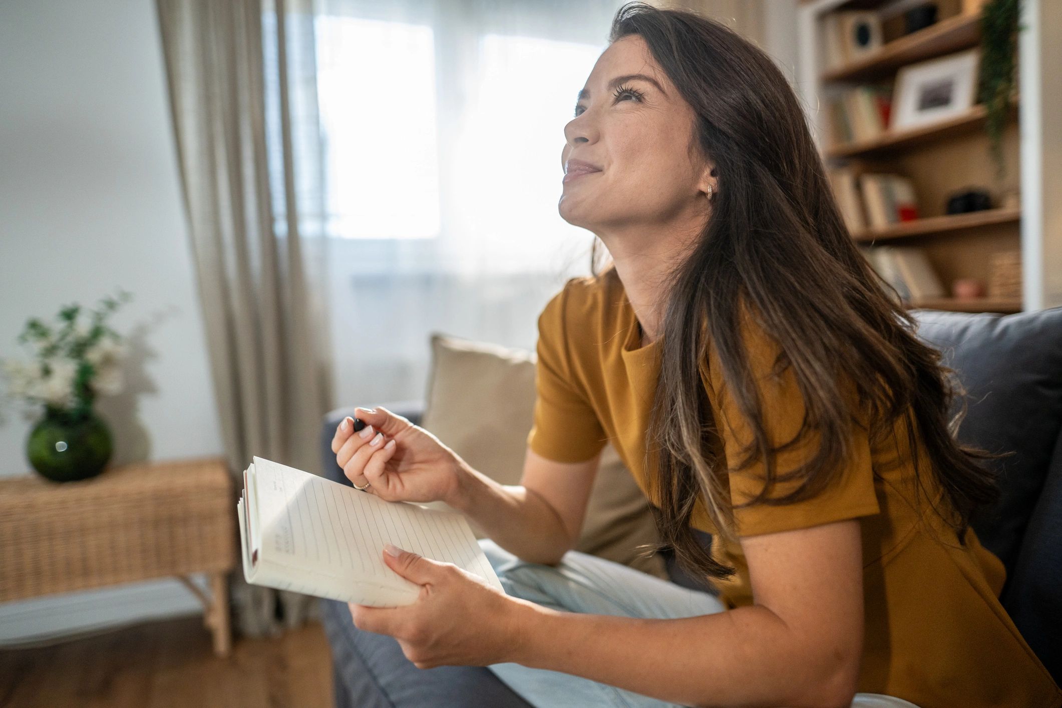 Person journaling and reflecting in warm light