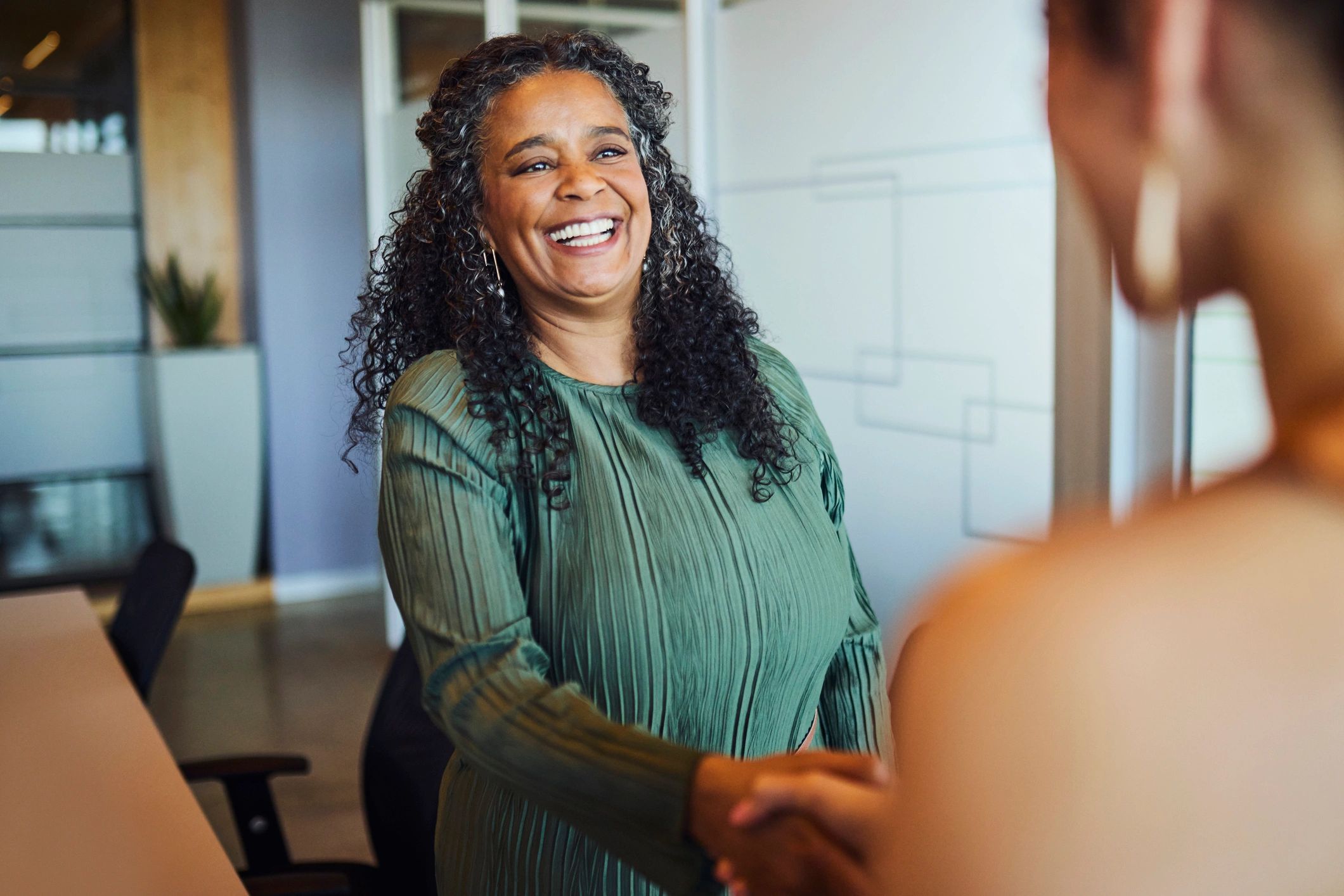 Professional handshake in a modern office